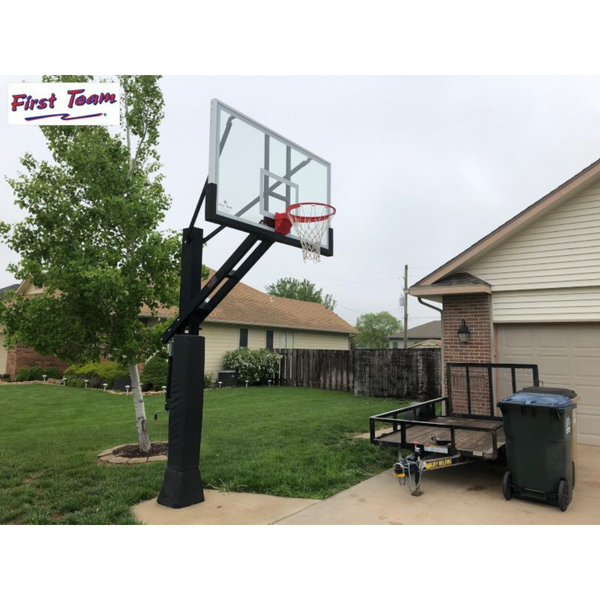 First Team Stainless Olympian In Ground Adjustable Basketball Goal angled view in front of a garage-First Team-Game Room Shop