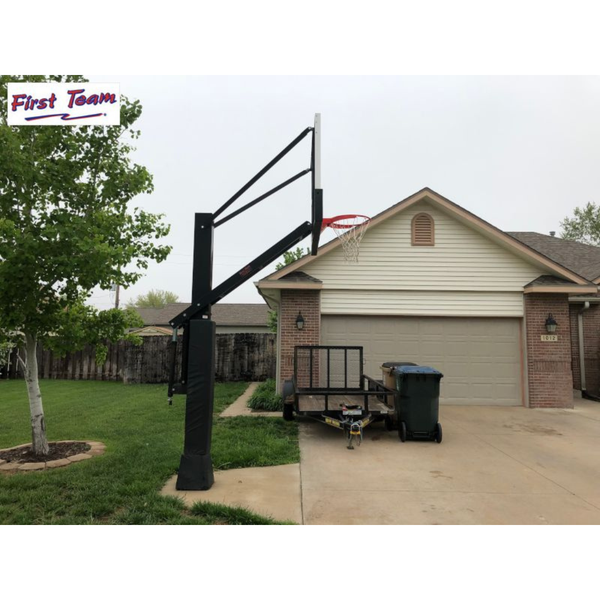 First Team Stainless Olympian In Ground Adjustable Basketball Goal side view in front of a garage-First Team-Game Room Shop